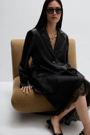 Style inspiration: woman sitting and wearing a leather blazer outfit